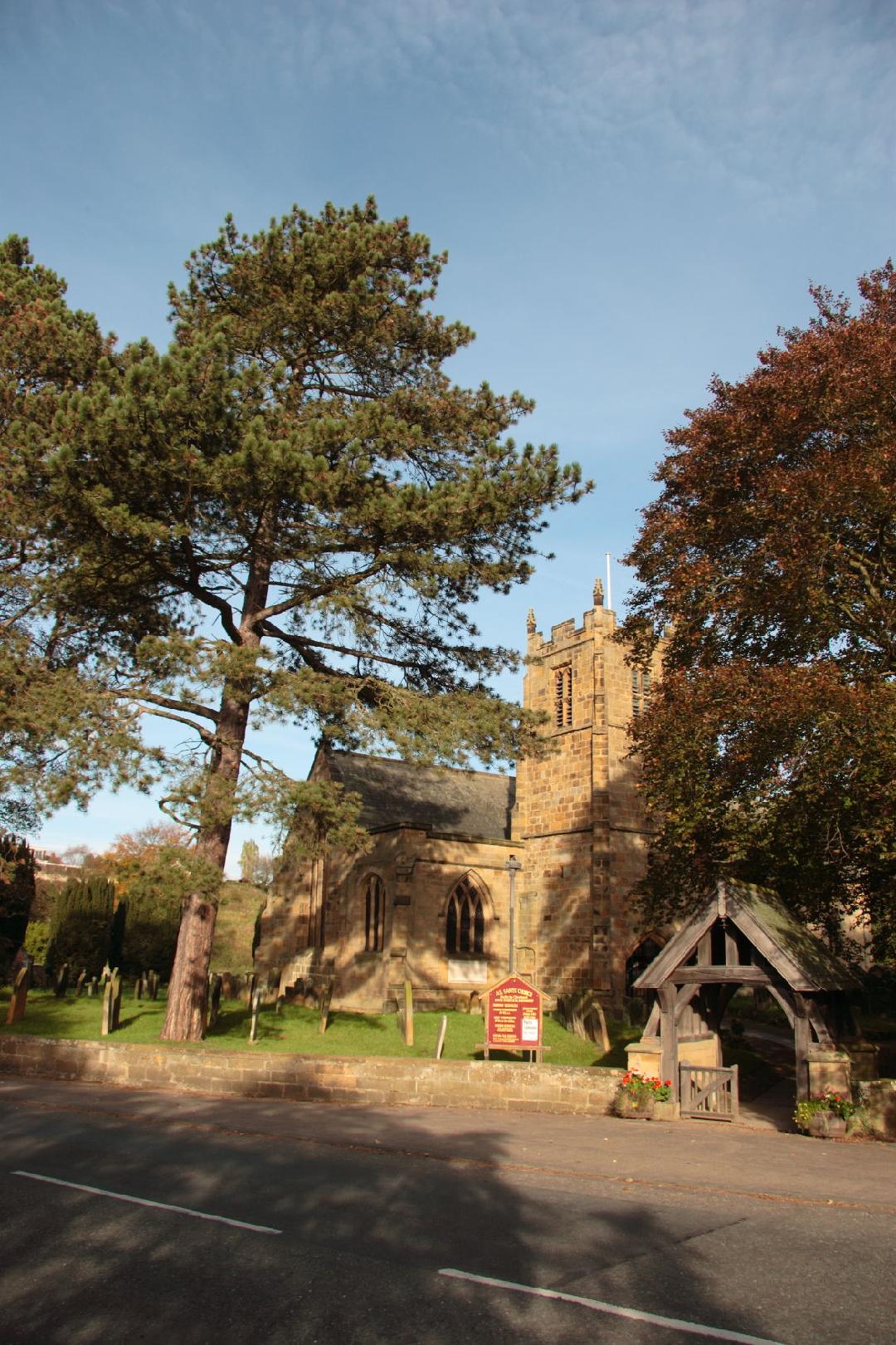 Photograph of All Saints Parish Church and the lych gate/>
                                <div id=